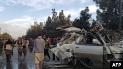 The remains of a minivan after one of two bombings in Kabul on November 17.