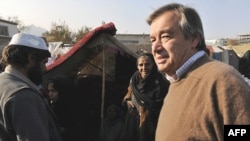 UN High Commissioner for Refugees Antonio Guterres (right) inspects a camp for displaced Afghans in Kabul last November.