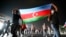 People carry an Azerbaijani national flag as they rallied in Baku on July 14.