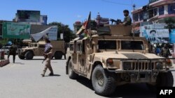 Afghan security forces sit in a Humvee vehicle amid ongoing fighting with Taliban militants in Kunduz in May.