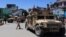 Afghan security forces sit in a Humvee vehicle amid ongoing fighting with Taliban militants in Kunduz in May.