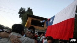 Carlos Barrios, one of the 33 rescued San Jose miners, hugs a friend on his return home in Copiapo.