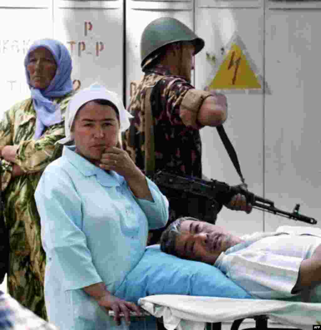 A nurse waits with an injured patient at a hospital in Andijon on May 14 - What's clear is that Uzbek security forces fired on a large crowd of protesters gathered in the central square of Andijon.