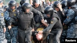 Riot police detain a protester during an opposition rally in Moscow. (file photo)