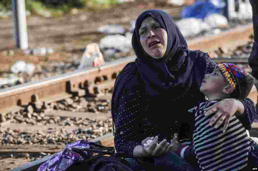 A woman holding her child cries at the Hungary-Serbia border, near the town of Horgos. A record 5,809 migrants entered Hungary in a new surge on September 13, smashing the previous day&#39;s record of 4,330, Hungarian police said on September 14. (AFP/Armend Nimani)