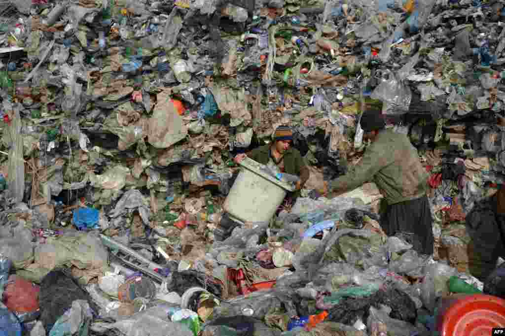 Afghan youth collect metal and plastic from a landfill to sell for recycling on the outskirts of Mazar-e Sharif. (AFP/Farshad Usyan)