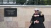 Russian Navy servicemen console each other ahead of a funeral service for 14 sailors who died in a submarine fire in the Barents Sea. 