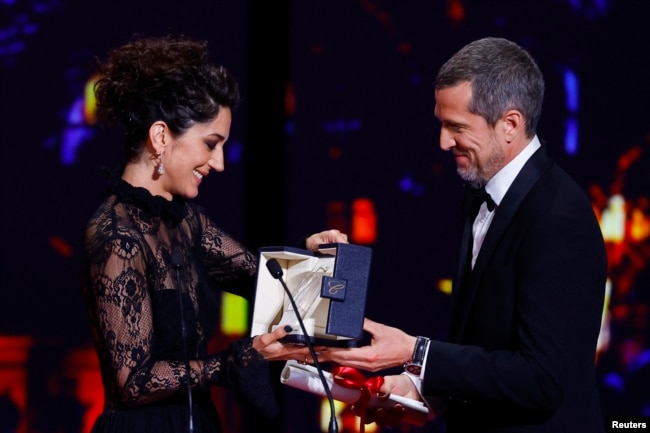 Zar Amir Ebrahimi, who lives in exile in France, accepting the Best Actress award at Cannes.