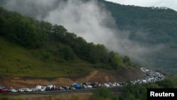 Vehicles carrying refugees from Nagorno-Karabakh queue on the road leading towards the Armenian border, September 25, 2023. 