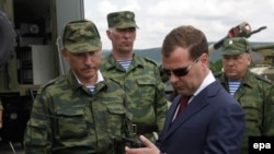 Russian President Dmitry Medvedev inspects the paratroopers' equipment as he visits the a training ground in Novorossiisk region.