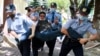 Kazakh police detain a demonstrator during opposition protests in June 2020 in Almaty.