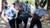 Полиция уносит задержанного на месте, которое анонсировалось как точка сбора для проведения антиправительственного митинга. Алматы, 6 июня 2020 года