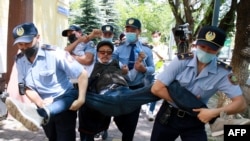 Kazakh police detain a demonstrator in Almaty during a demonstration called by the Democratic Choice of Kazakhstan in June 2020.