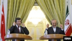 Miniștrii de externe ai Turciei, Ahmet Davutoglu și Iranului Manoucher Mottaki