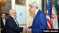 Iranian Foreign Minister Mohammad Javad Zarif (left) shakes hands with U.S. Secretary of State John Kerry at their meeting in Vienna on July 14.