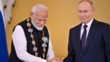 Russian President Vladimir Putin decorates Indian Prime Minister Narendra Modi with the Order of St. Andrew the Apostle the First-Called during a ceremony following their talks at the Kremlin in Moscow on July 9. 