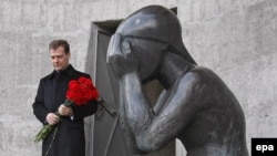 President Dmitry Medvedev lays flowers at a monument honoring victims of Stalin purges
