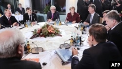 German Chancellor Angela Merkel (back, center) hosted talks in Berlin with Russian President Vladimir Putin (left) and Ukrainian President Petro Poroshenko on the crisis in Ukraine.