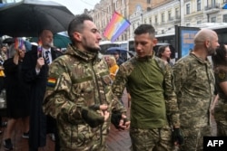 Ukrainian soldiers and LGBT community activists take part in Kyiv Pride 2024 on June 16.