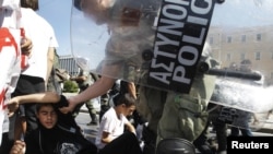 Riot police remove student protesters during an antiausterity demonstration in Athens. 