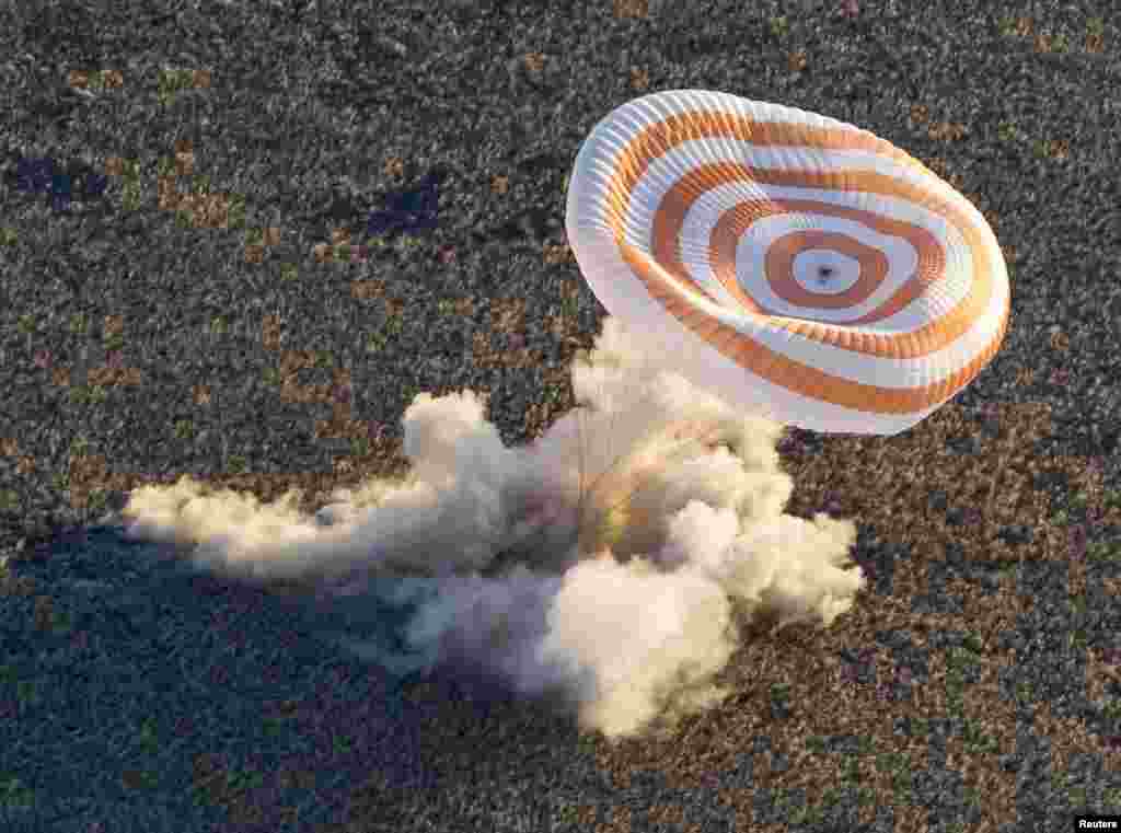 A &quot;Soyuz&quot; TMA-09M capsule carrying the ISS crew of Karen Nyberg, Fyodor Yurchikhin, and Luca Parmitano lands in a remote area near the town of Zhezkazgan, Kazakhstan, in November 2013. The three returned to Earth with an Olympic torch that was displayed in open space as part of Russia&#39;s preparations for the Sochi 2014 Winter Games.