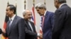 Iranian Foreign Minister Mohammad Javad Zarif (second from left) shakes hands with U.S. Secretary of State John Kerry as Chinese Foreign Minister Wang Yi (far left) and French Foreign Minister Laurent Fabius (far right) mark the nuclear deal in Geneva early on November 24.