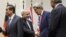 Iranian Foreign Minister Mohammad Javad Zarif (second from left) shakes hands with U.S. Secretary of State John Kerry as Chinese Foreign Minister Wang Yi (far left) and French Foreign Minister Laurent Fabius (far right) mark the nuclear deal in Geneva early on November 24.