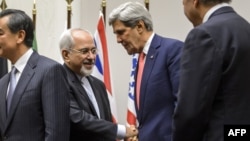 Iranian Foreign Minister Mohammad Javad Zarif (left) shakes hands with U.S. Secretary of State John Kerry following talks in Geneva in early November.