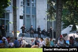 PDM supporters sit outside government headquarters in Chisinau on June 10.