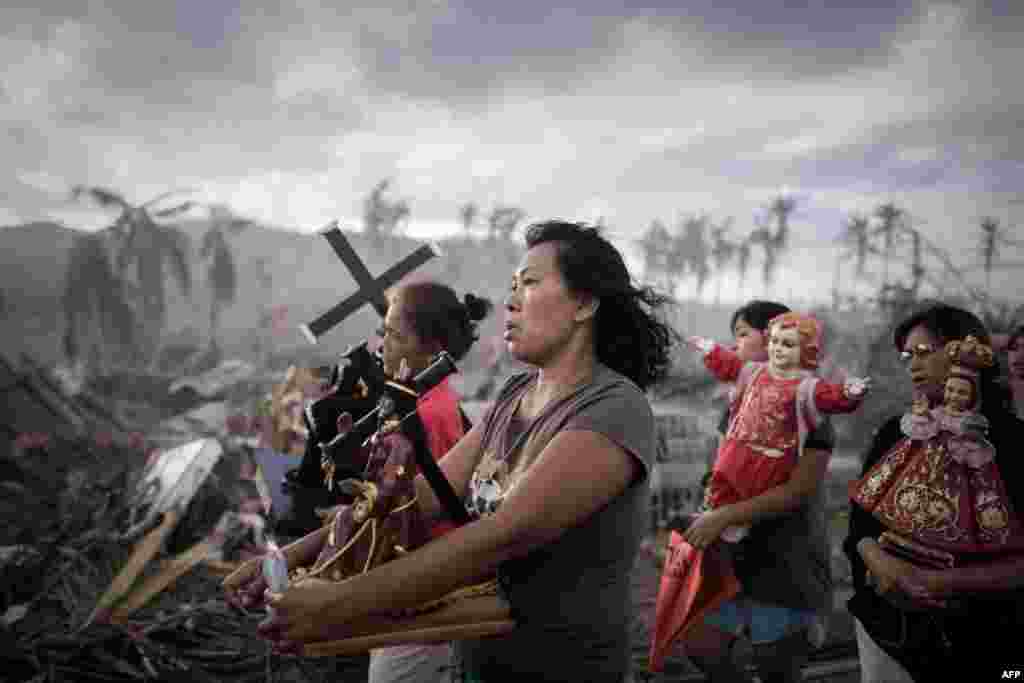 Survivors of Super Typhoon Haiyan march during a religious procession in Tolosa on the eastern island of Leyte on November 18, over a week after the typhoon devastated the area. (AFP/Philippe Lopez)