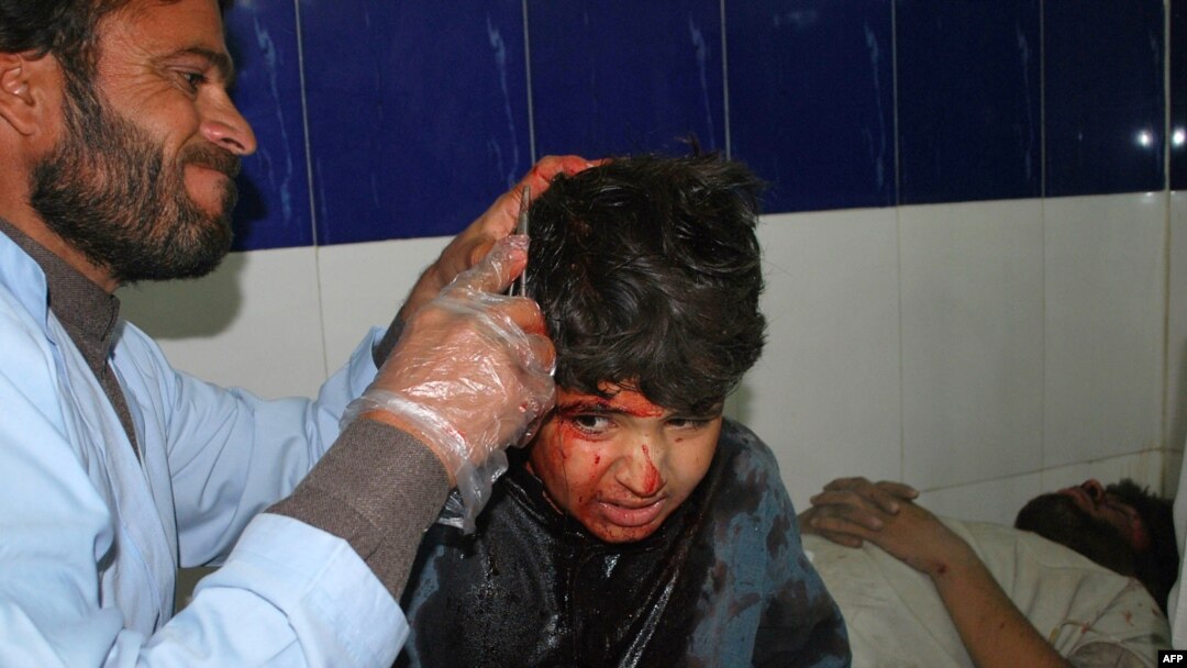 A paramedic treats an injured boy at a Quetta hospital following a car bomb blast on December 30 that killed at least eight people.