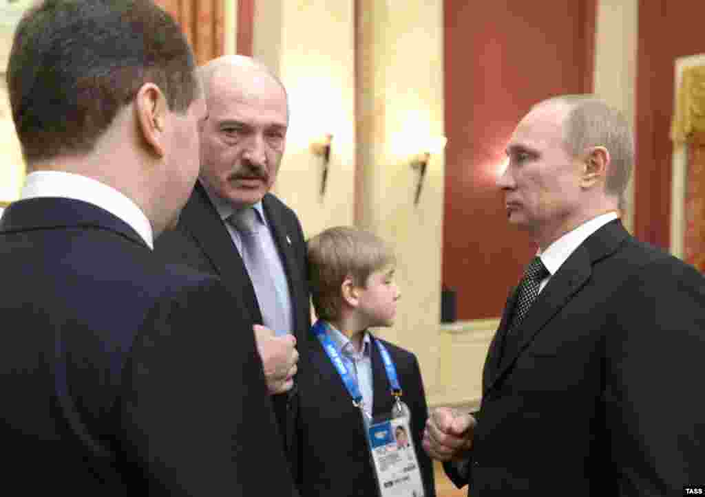 Russian Prime Minister Dmitry Medvedev (left), Lukashenka, Kolya, and Russian President Vladimir Putin chat at a reception for high-profile guests at the Winter Olympics in Sochi in February 2014.