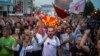 Protesters shout slogans in front of the parliament building in Skopje on April 18.