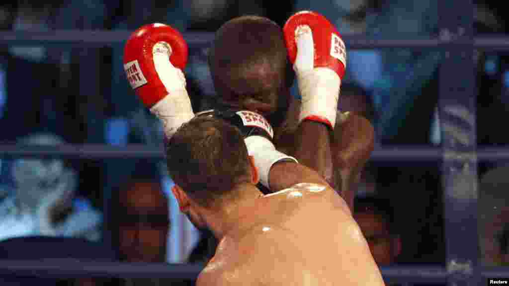 Afghan boxer Hamid Rahimi punches Said Mbelwa of Tanzania during their World Boxing Organization Intercontinental middleweight fight in Kabul on October 30. A joyous Kabul crowd invaded the ring to celebrate a local victory in Afghanistan's first professional men's boxing match in decades after Rahimi beat Mbelwa in seven rounds. (Reuters/Omar Sobhani)