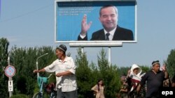 Анжиян, 2005-жыл, 17-май. Ошол кездеги президент Ислам Каримовдун жарнама тактага илинген сүрөтү.