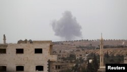 Smoke rises from a base controlled by rebel fighters from the Ahrar al-Sham Movement that was targeted by what activists said were Russian airstrikes in Syria's Idlib Province on October 1.