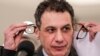 Lebanon -- Nizar Zakka, a Lebanese national and US resident arrested in Iran in 2015 and sentenced to 10 years in jail on espionage charges, takes off his glasses following reading a statement during a press conference after he was freed, at the president