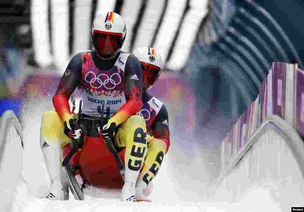 Germany&#39;s pilot Tobias Wendl (front) and Tobias Arlt take part in the men&#39;s luge doubles competition. They won the gold.