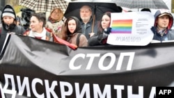 A woman holds a placard reading "Stop discrimination" as she takes part in a rally of Ukrainian activists and representatives of the lesbian, gay, bisexual, and transgender community in front of parliament in Kyiv in November 2015.