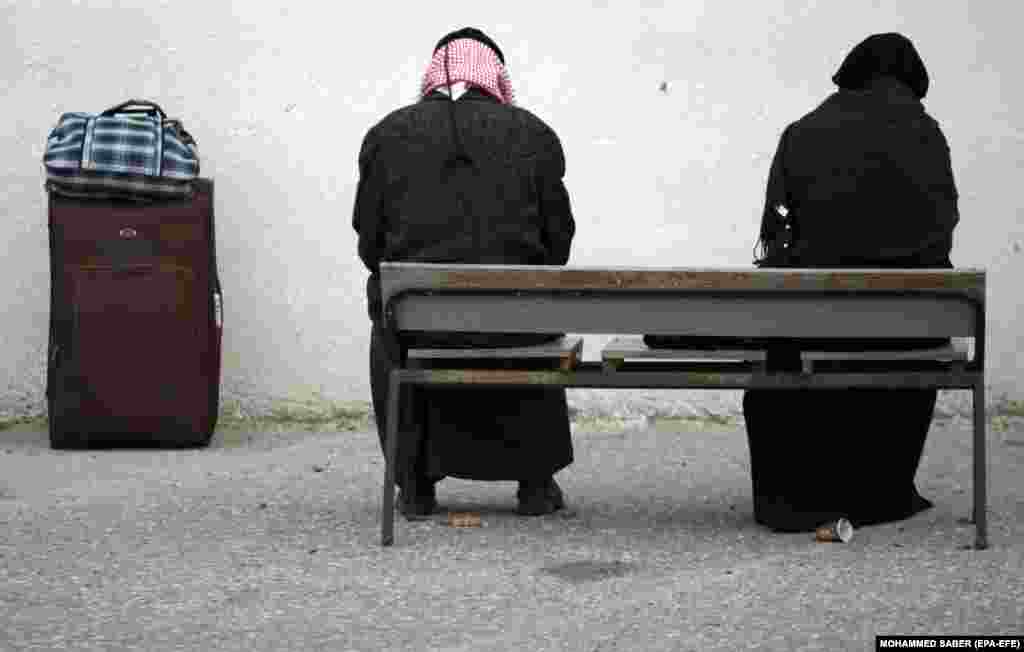 A Palestinian couple waits to cross into Egypt through the Rafah border crossing between the Gaza Strip and Egypt. Egyptian authorities reopened the Rafah crossing for three days for humanitarian cases, as well as for students enrolled at Egyptian universities and Gazans with jobs abroad. (epa-EFE/Mohammed Saber)