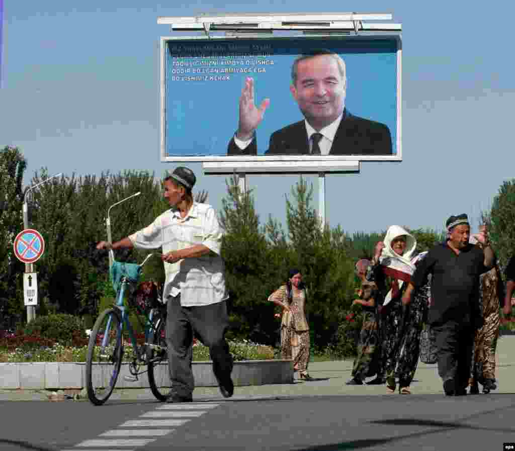 A billboard of President Karimov smiles over a street in Andijon - Uzbek President Islam Karimov has maintained that the unrest in Andijon was organized by international extremist groups with support from Islamists outside the country, and has refused to fulfill demands for an independent probe into the events. No high-ranking government officials have been held responsible for the deadly use of force.