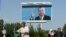 A portrait of President Karimov hangs over an Andijon street on May 17, 2005