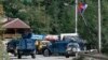 Kosovar police deploy armored vehicles at barricades installed by local Serbs near the northern border crossing of Brnjak, on September 24. 