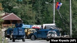 Kosovar police deploy armored vehicles at barricades installed by local Serbs near the northern border crossing of Brnjak, on September 24. 