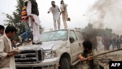 Afghanistan -- A crowd of protestors vandalizes a car during clashes with police following Friday prayers in Kabul, 30Jul2010
