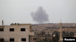 Smoke rises from a base controlled by rebel fighters from the Ahrar al-Sham Movement that was targeted by what activists said were Russian airstrikes in Syria's Idlib Province on October 1.