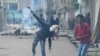 FILE: A Kashmiri protestor throws a stone towards Indian government forces during clashes in Srinagar.