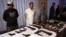 Pakistani security official displays weapons recovered during a security operation in Karachi on November 7, 2016.