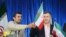 Ahmadinejad (left) handing an Iran flag to Mashaei, his vice president, in Semnan, Iran, on April 11, 2013.