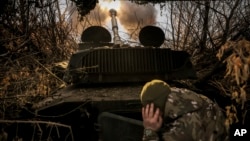 Ukrainian soldiers of the 24th Mechanized Brigade fire a 2s1 self-propelled 122mm howitzer toward Russian positions near Chasiv Yar in the Donetsk region on November 13.